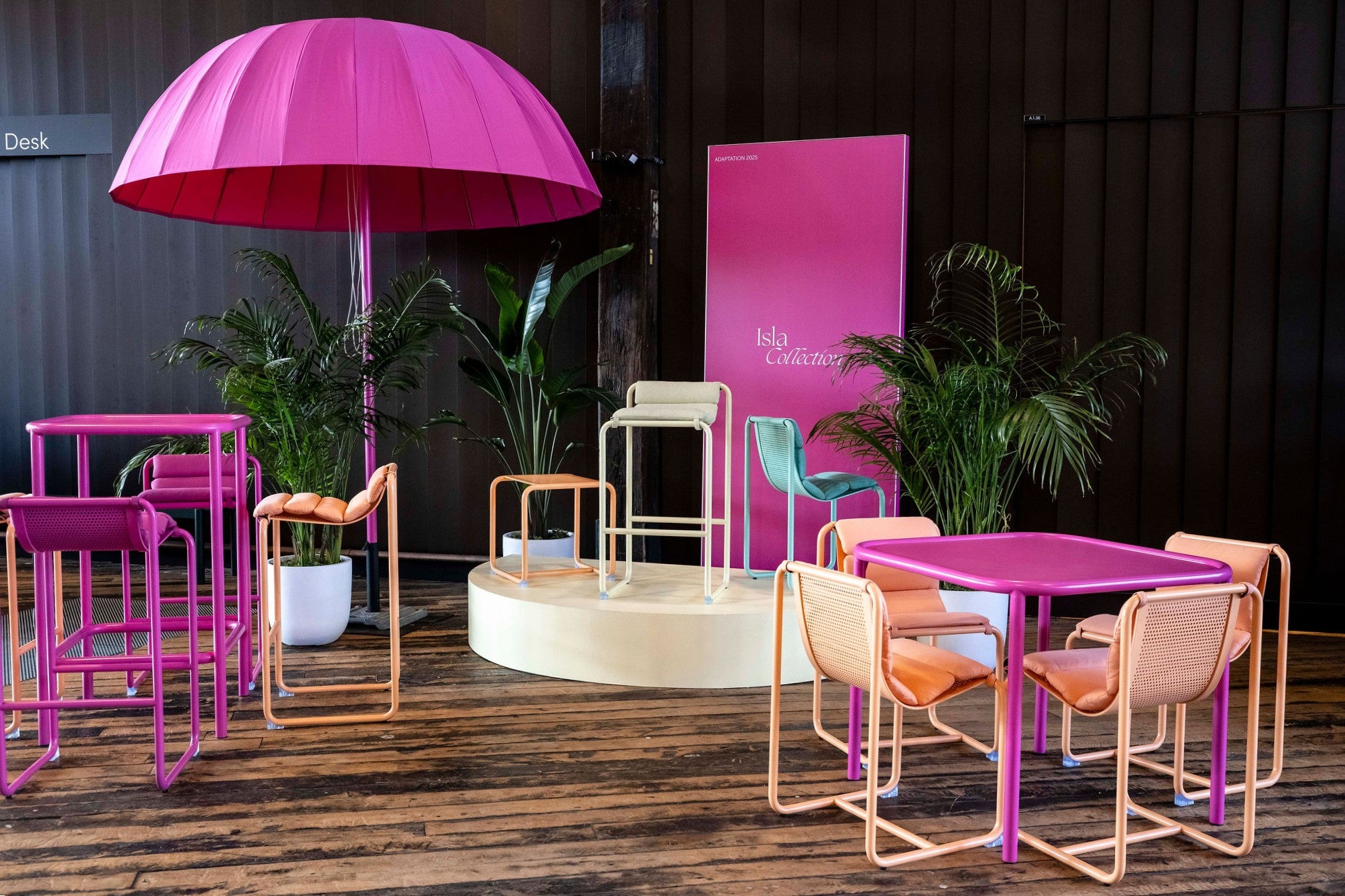 Modern outdoor furniture set with pink and orange chairs and table, and a large pink umbrella in Sydney