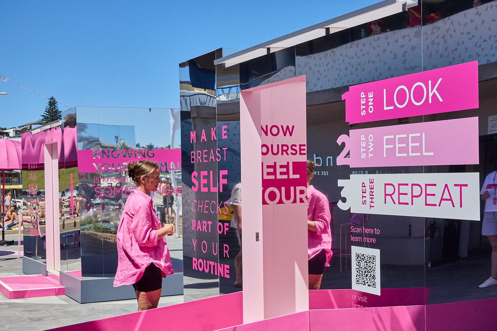 Pop up booth with pink and white signs for BCNA.