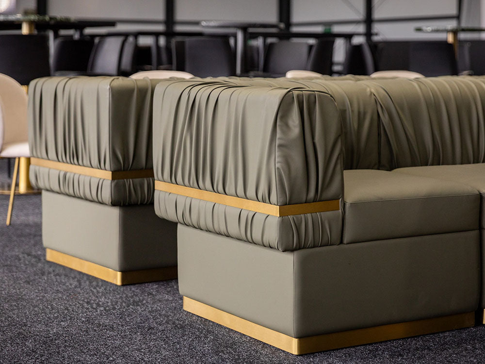 Row of green upholstered sofas with gold accents in a conference room setting. Onsite at a Spring Racing Carnival, Melbourne. Pictured: Rocco Modular