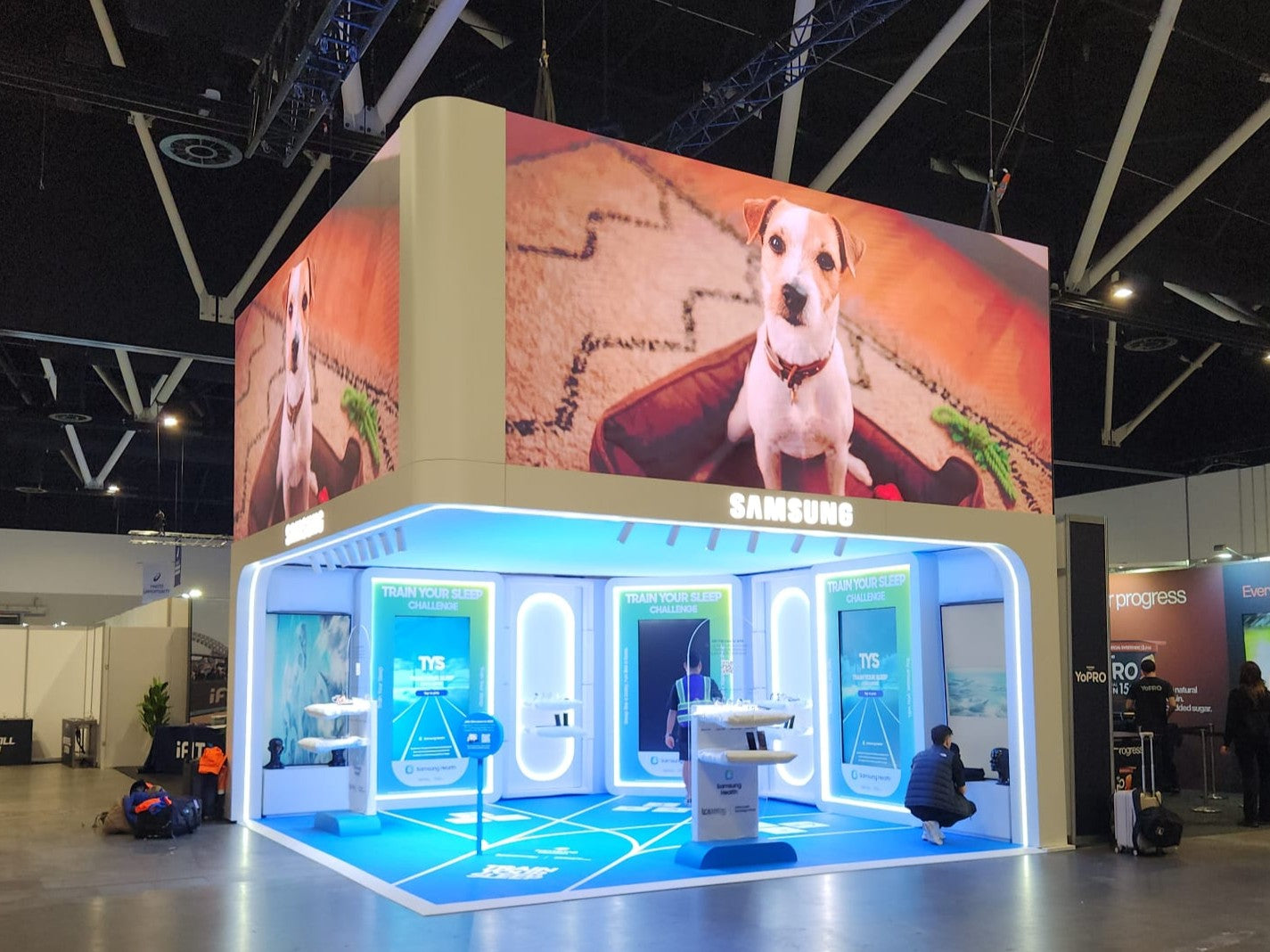 Samsung booth at a trade show with digital display and interactive area