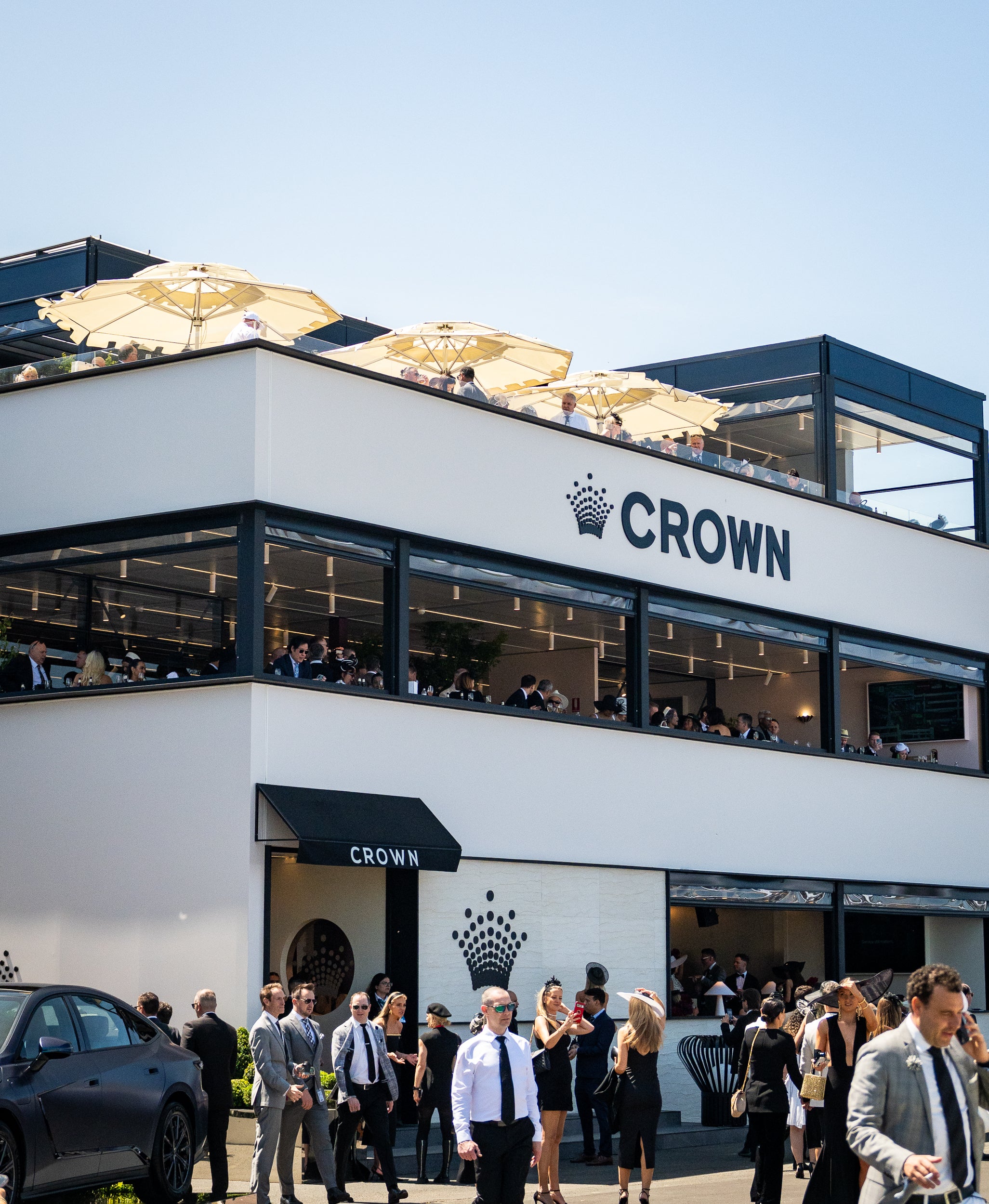 Crown marquee with people outside on a sunny day at Spring Racing Carnival