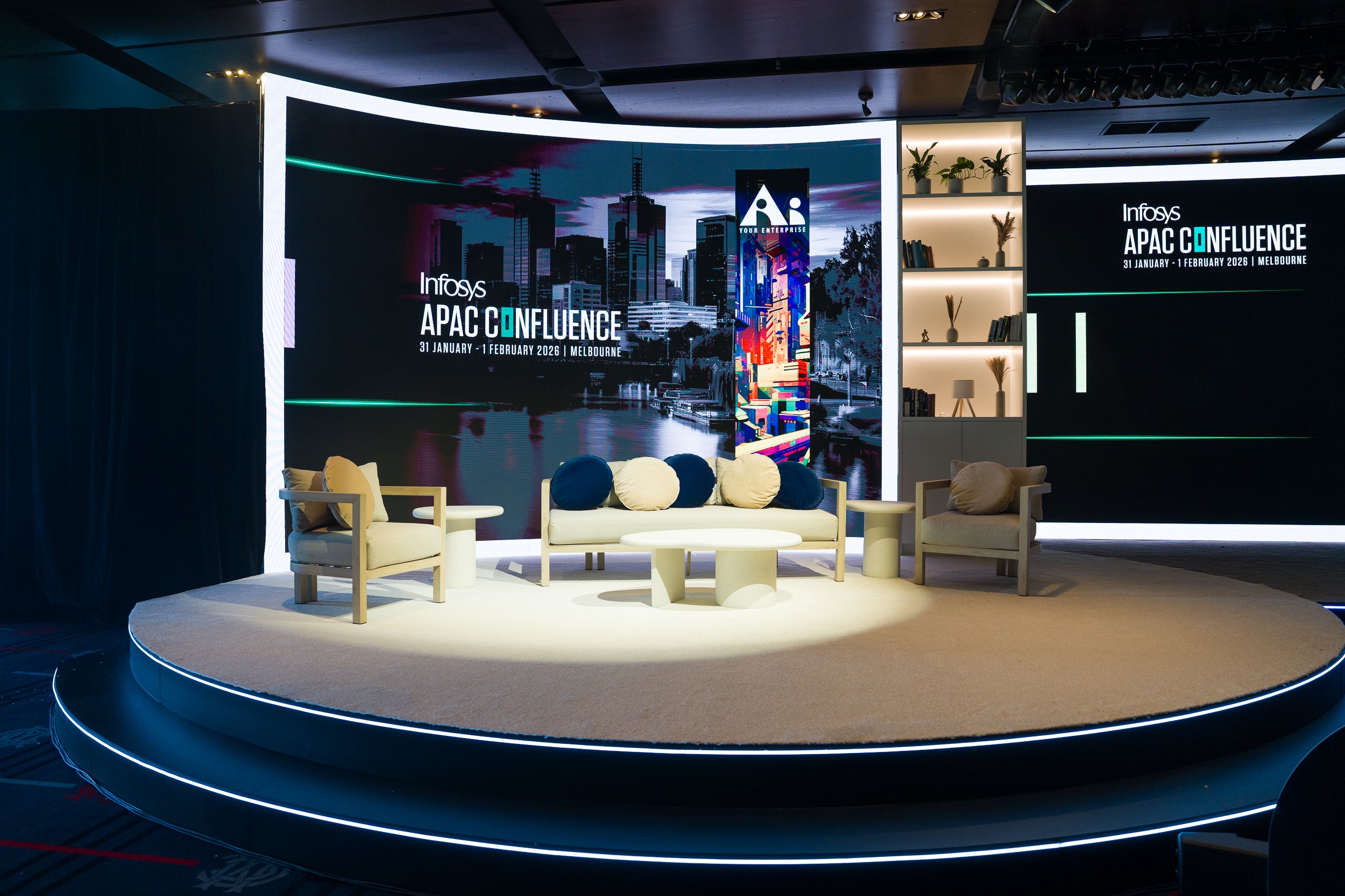 Stage setup with 'Infosys APAC Confluence' branding and cityscape background