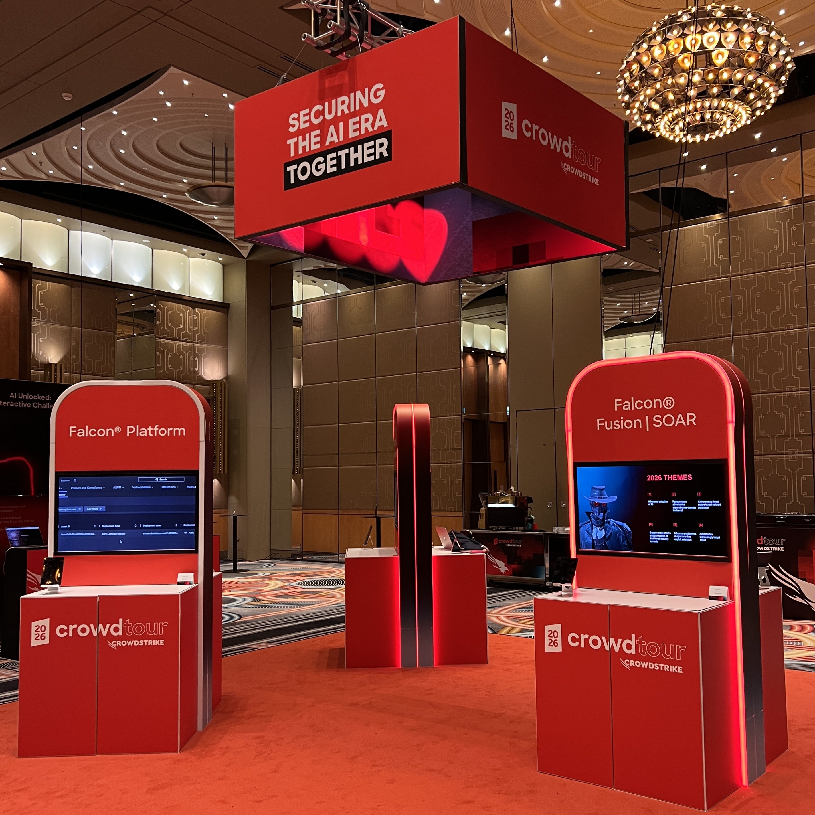 Red booths with 'crowd tour' branding in a conference setting
