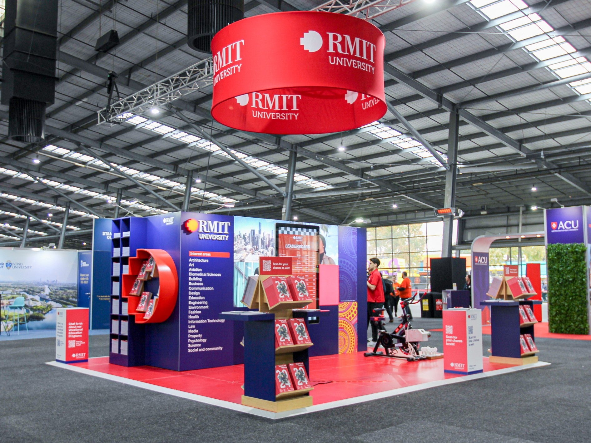 RMIT University exhibition stand with branded materials in a large indoor venue.