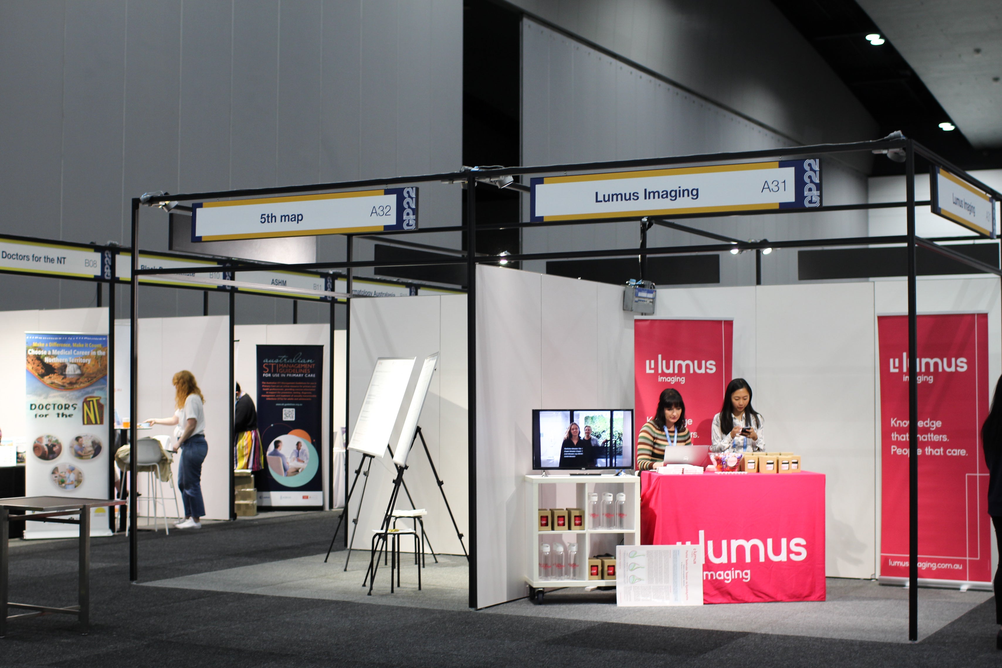 Exhibition booth with 'Lumus Imaging' branding at a trade show.
