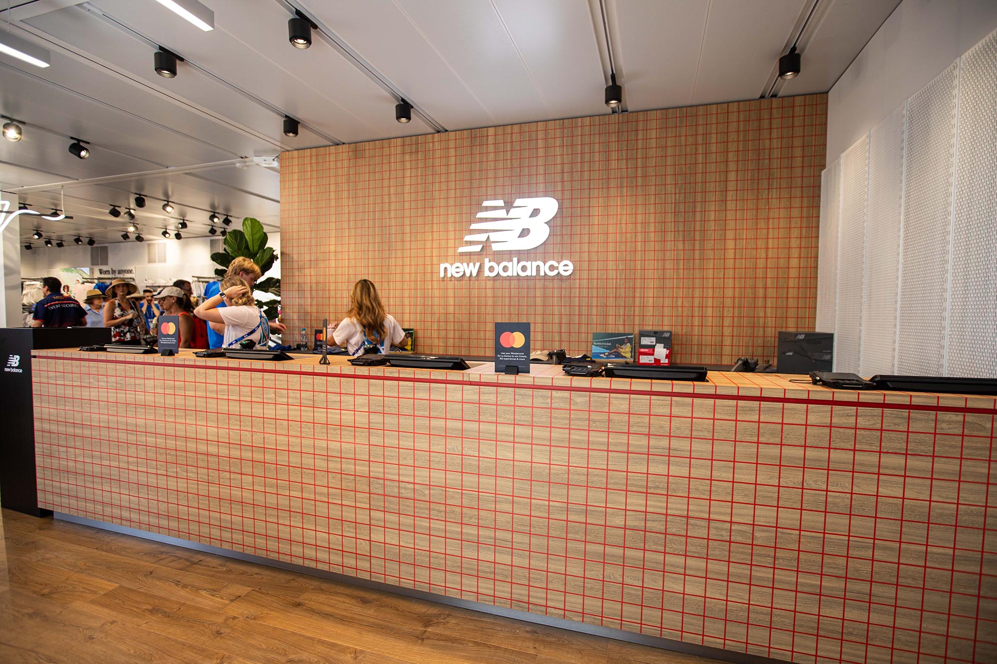 Counter with New Balance logo in a store setting