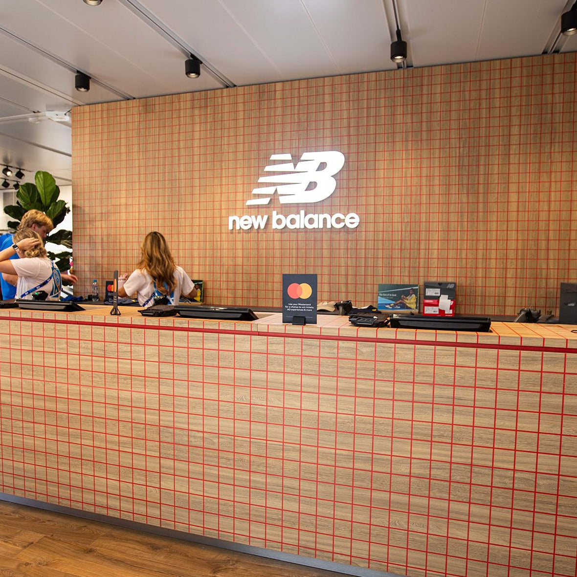 Counter with New Balance logo in a store setting