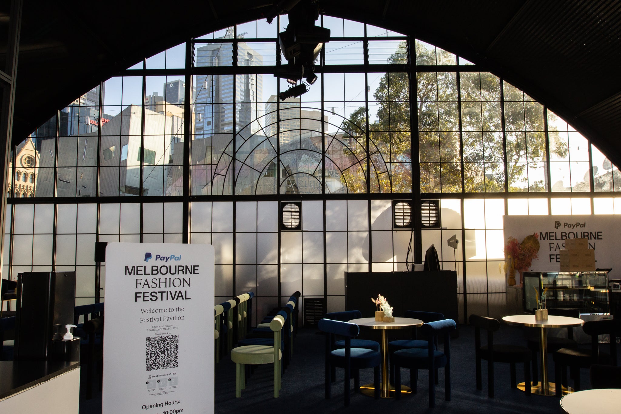 Melbourne Fashion Festival event space with large glass windows andPayPal branding. Harry the Hirer hire furniture can be seen.