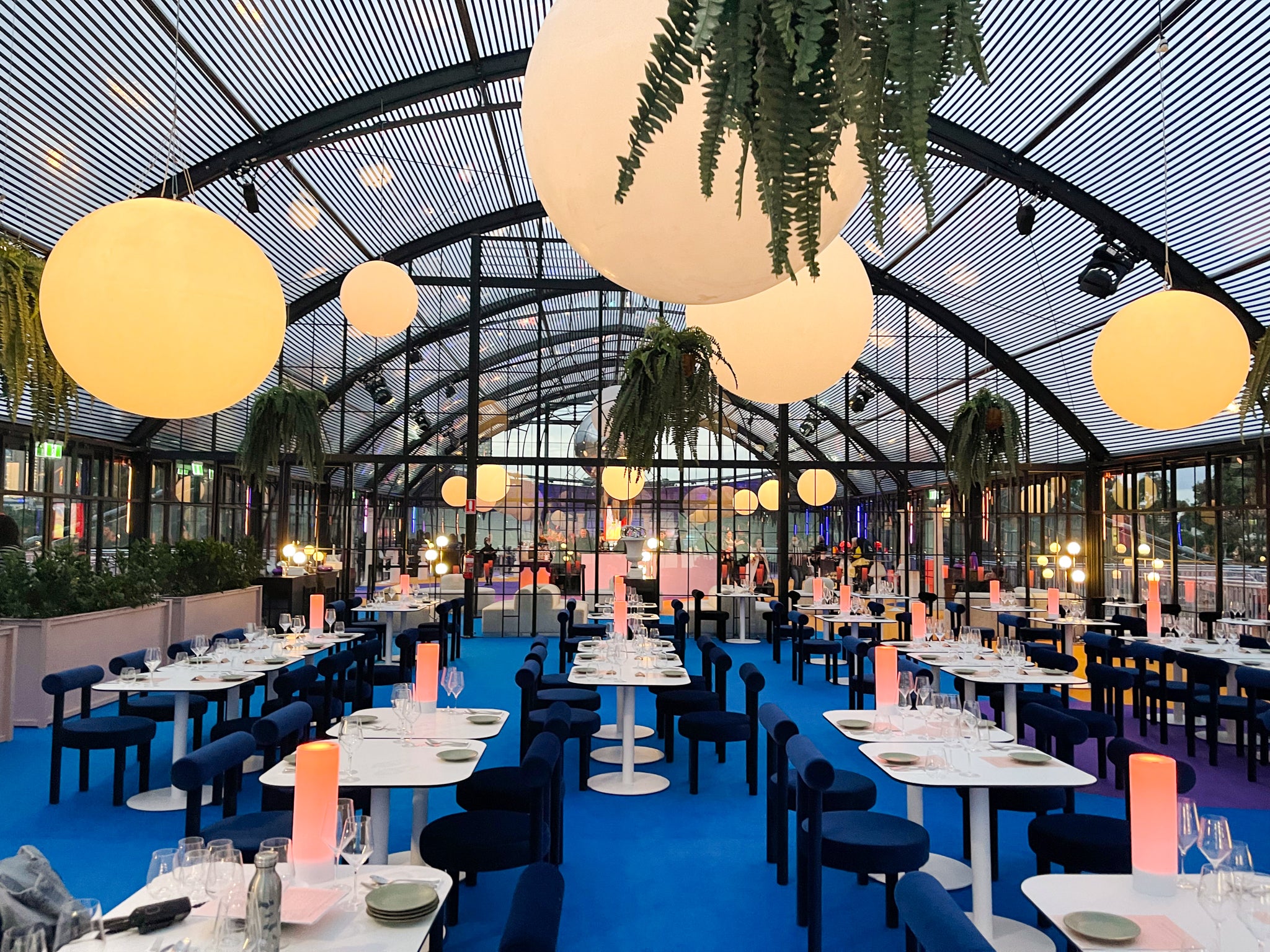Private wedding dining hall inside our Atrium marquee at dusk.