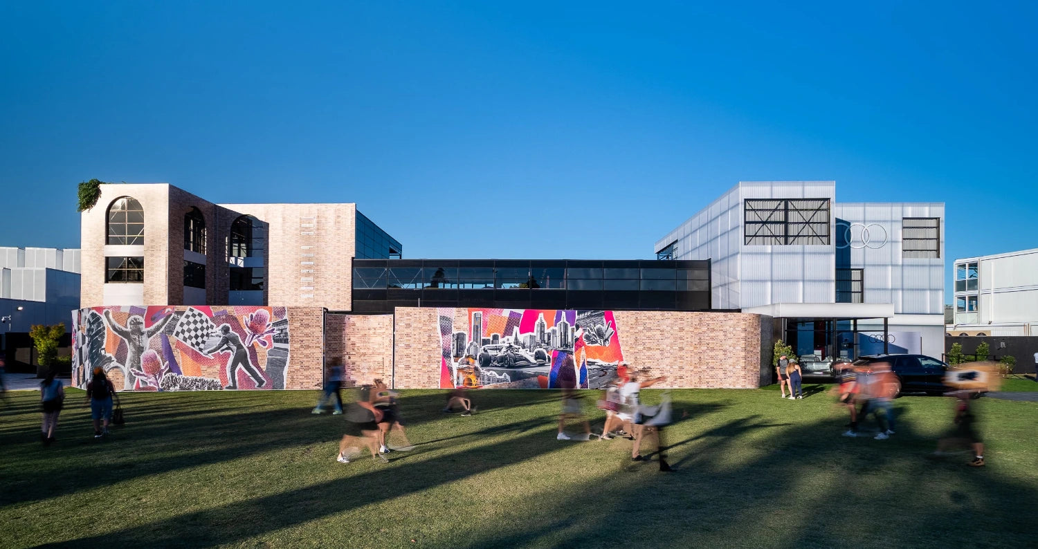 Highline Marquee at Grand Prix with a brick mural and people walking infront of it