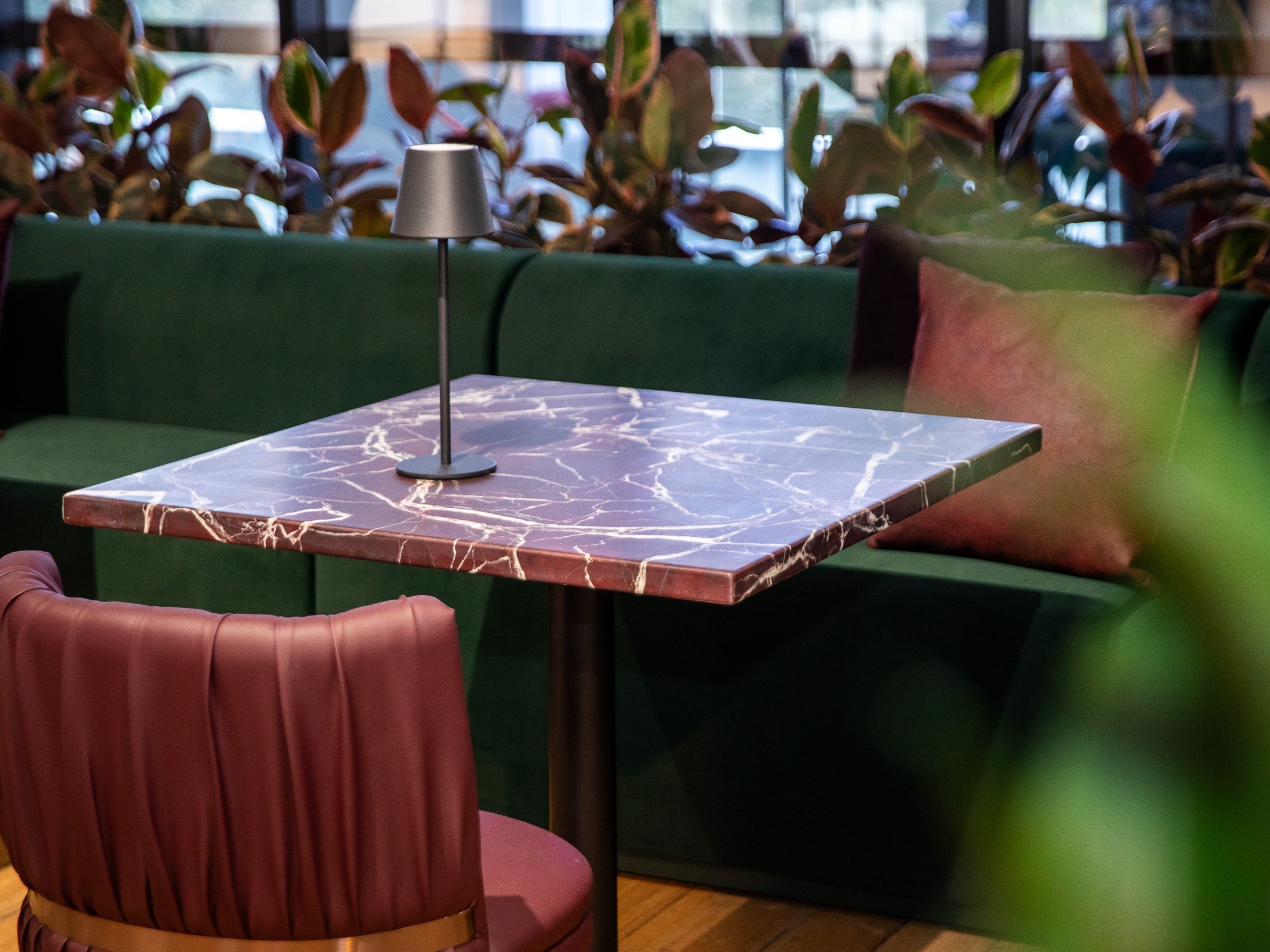 Halo marble table with a lamp and green sofa in the Melbourne Showroom