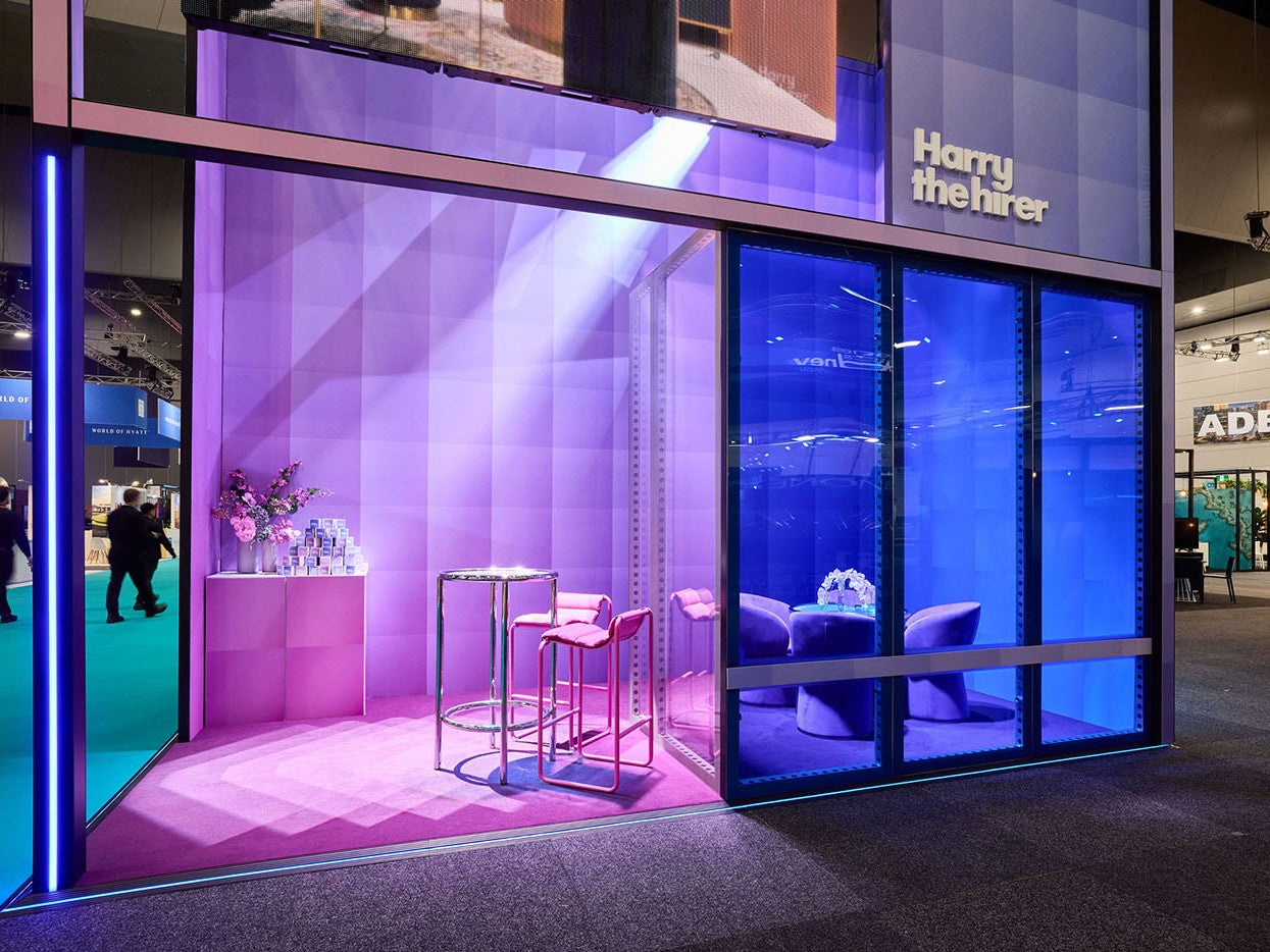 Beconstruct Marquee with purple and blue lighting, featuring furniture and decor.