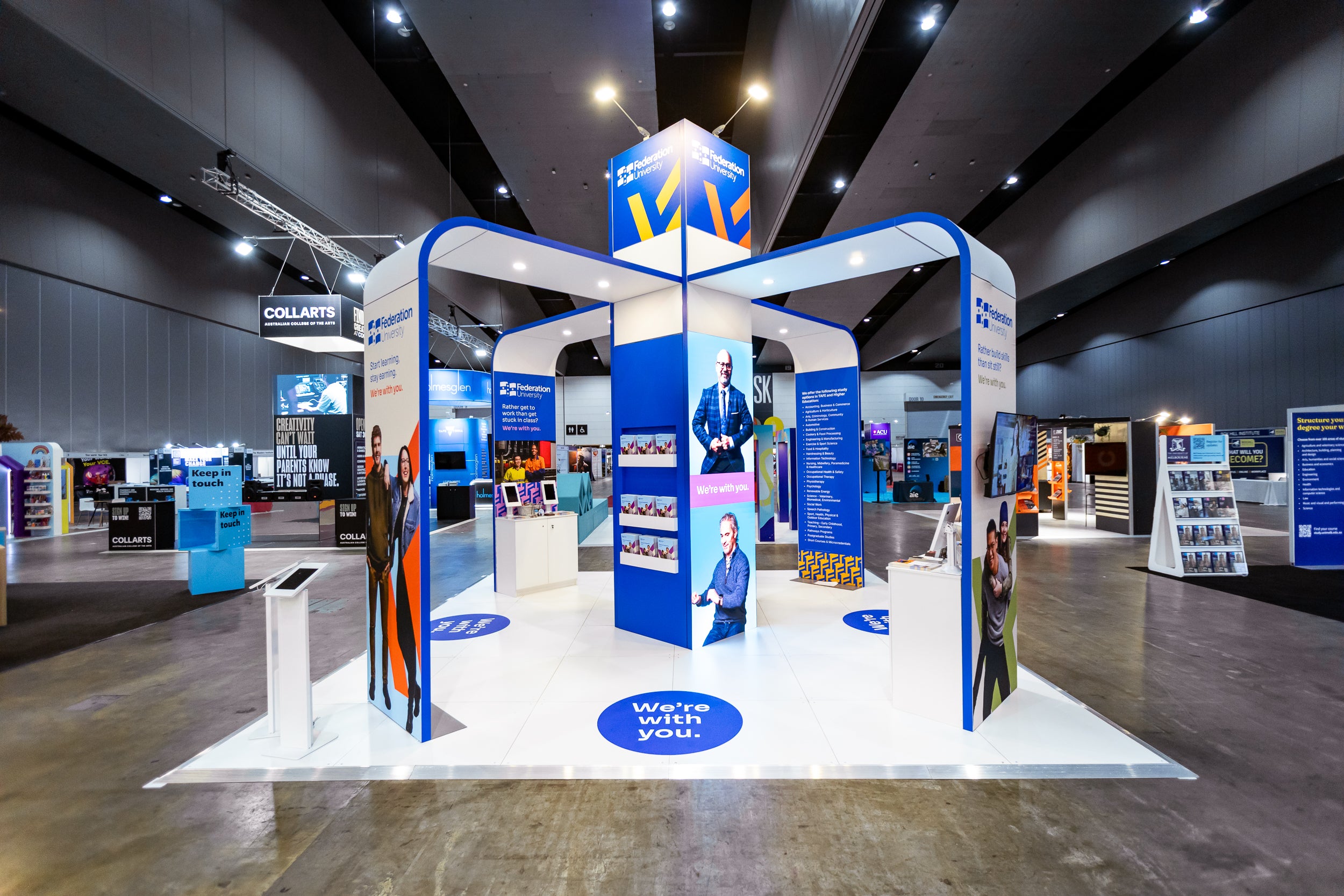 Exhibition stand with blue and white design in a large indoor space
