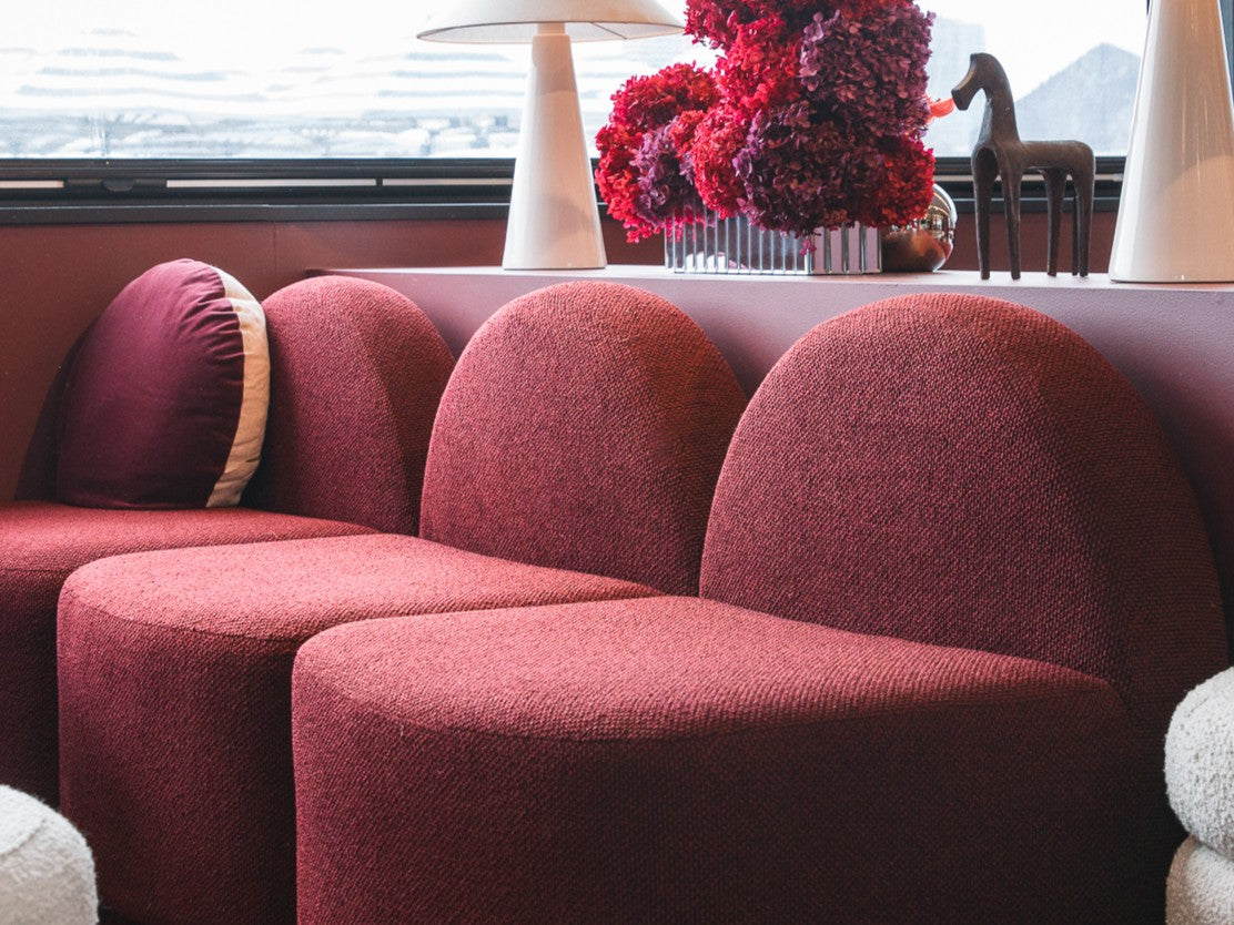 Red upholstered Harper seats in a marquee with a scenic view outside