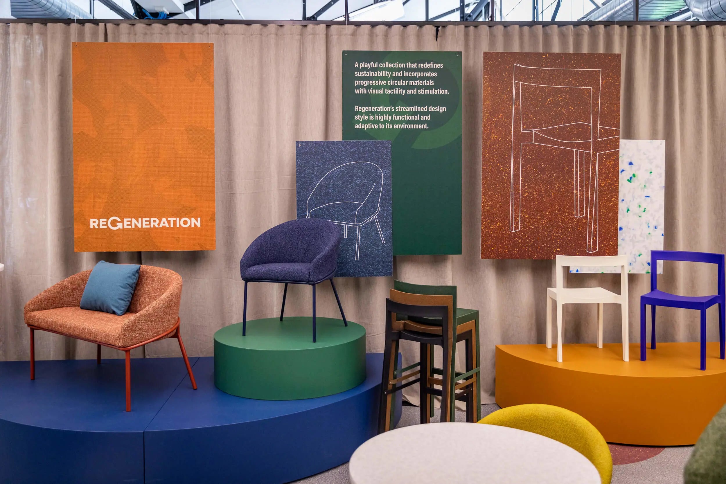 Display of furniture with 'ReGeneration' branding against a beige curtain.