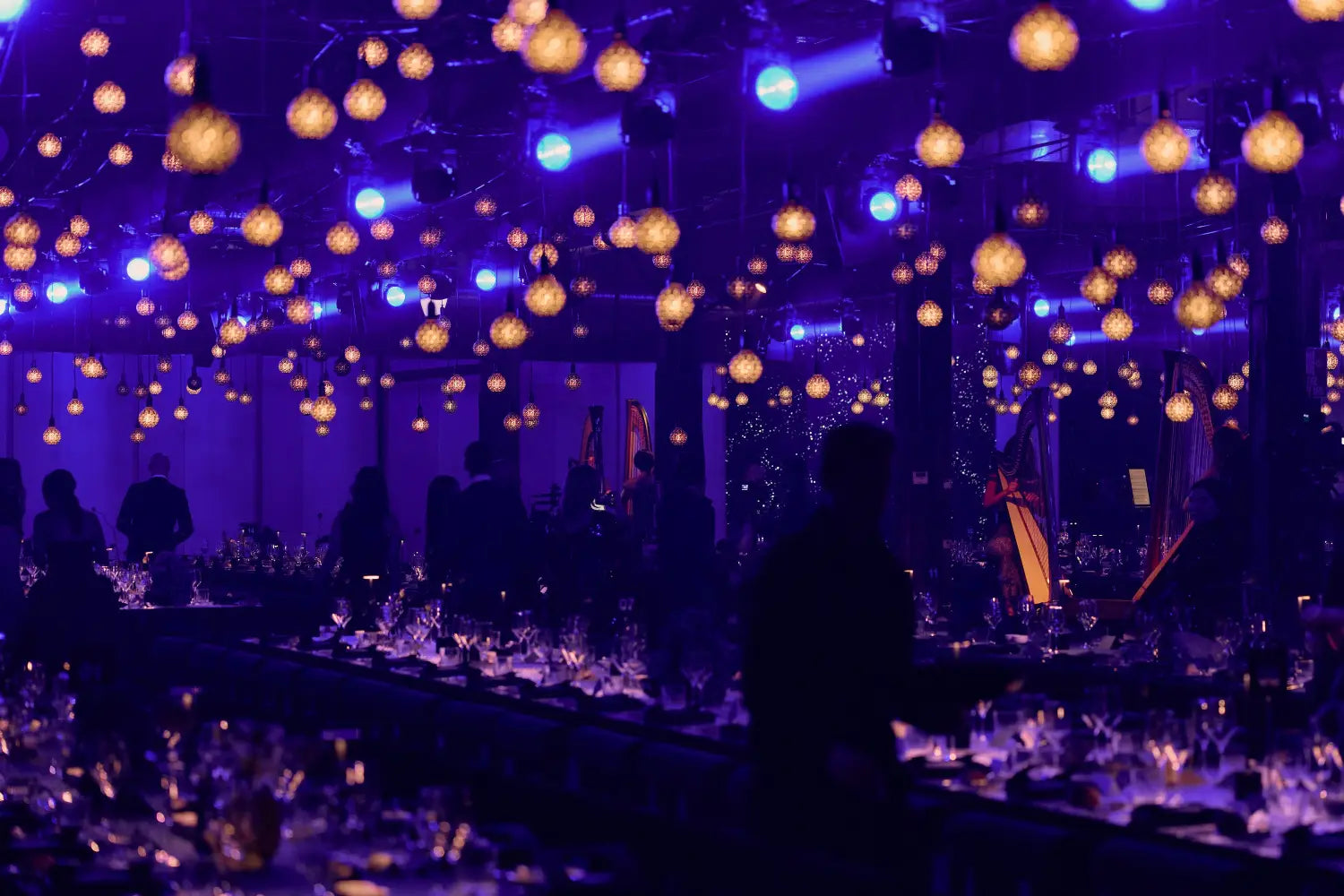 Indoors gala dinner with purple lighting and hanging lights